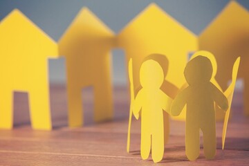 Paper people with houses on table