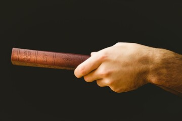 Close-up of hand holding Bible