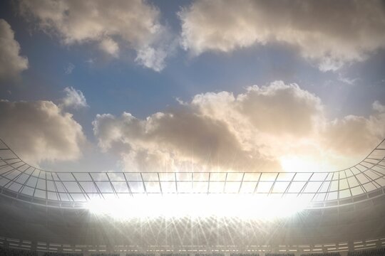 Fototapeta Large football stadium under cloudy blue sky