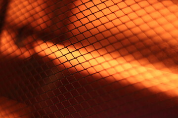 Abstract Bright Grid Pattern with Warm Orange Light Effect. Domestic electric heater