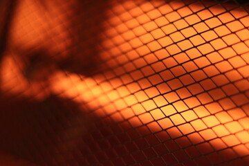 Abstract Bright Grid Pattern with Warm Orange Light Effect. Domestic electric heater