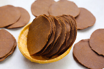 Sun-dried fermented soybean sheets called “Thua Nao,” a traditional ingredient in Northern Thai cooking.