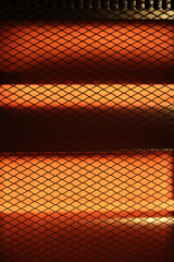 Abstract Bright Grid Pattern with Warm Orange Light Effect. Domestic electric heater