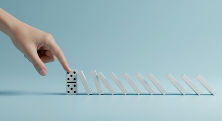 Starting Domino Effect with Hand on Blue Background