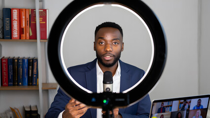 Confident man presenting virtually with ring light and laptop