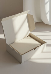 A creamcolored cardboard box sits open, displaying blank paper inside