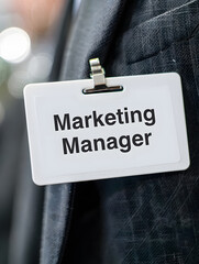 Marketing Manager ID Badge Hanging on a Dark Jacket