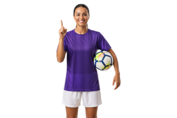 Smiling female soccer player in purple jersey holding ball and pointing up, isolated on transparent background