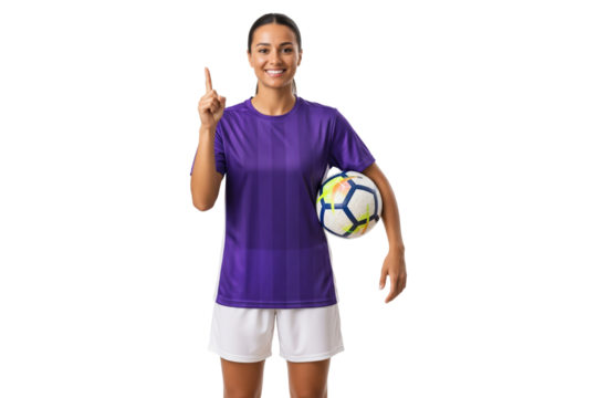 Smiling female soccer player in purple jersey holding ball and pointing up, isolated on transparent background