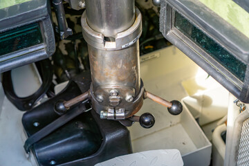 Interior of armored vehicle showing turret rotation mechanism with control levers and sighting...