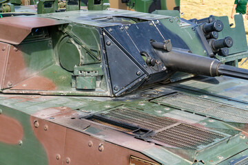 Infantry fighting vehicle turret with mounted automatic cannon, close-up of armored military weapon...