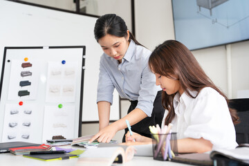 Fototapeta premium interior designer working on new house design project in office. choosing loose furniture materials and colors from samples.