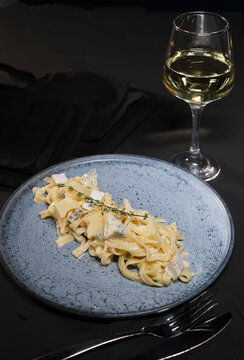 Traditional pasta with blue cheese, olive oil, micro greens. View from above. Spaghetti pasta with blue cheese