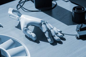 Plastic hand printed on 3D printer. Human arm prosthesis created on a 3D printer from molten...