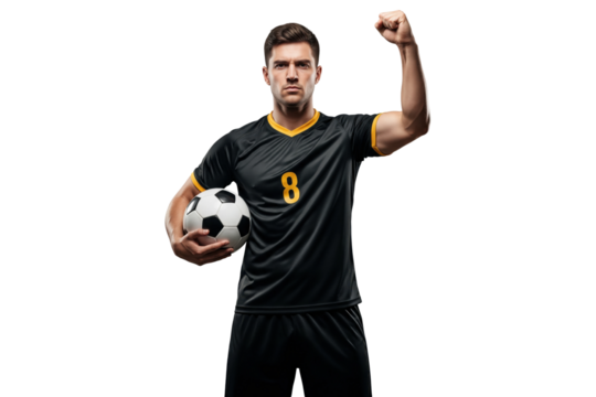 Male soccer player in black and yellow uniform holding ball and raising fist isolated on white
