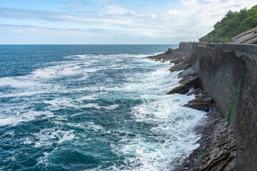 Breakwater on the promenade of the city of San Sebastian where huge waves break, Basque Country