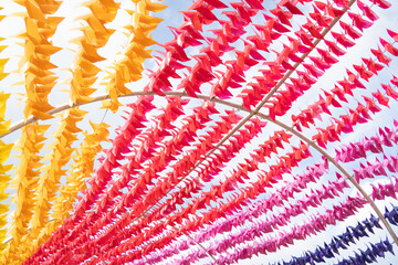 Colorful plastic toy pinwheels spinning fast in the wind at an open public park.