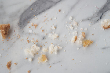 Crumbs scattered on a marble surface after a meal