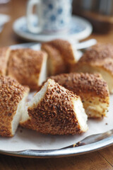 Freshly baked sesame bread rolls on a silver tray