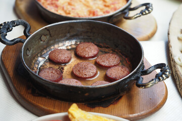Delicious sausages served in a traditional skillet