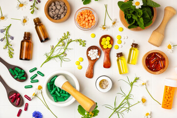 Alternative medicine herbal capsule organic drug on wooden background.Assortment of herbal and...
