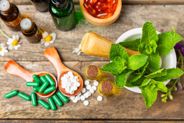 Alternative medicine herbal capsule organic drug on wooden background.Assortment of herbal and tablets,vitamins and dietary supplements.medicinal and Healing herbs.natural supplements for healthy life