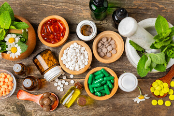 Alternative medicine herbal capsule organic drug on wooden background.Assortment of herbal and tablets,vitamins and dietary supplements.medicinal and Healing herbs.natural supplements for healthy life