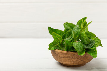 Mint. Fresh organic mint leaves on wooden background. Mint leaves. Peppermint. Close-up. Space for text. Copy space.