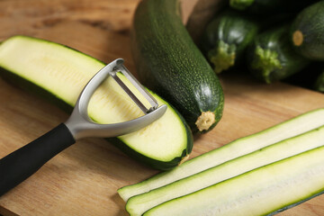 Fresh green zucchini and board with slices, closeup