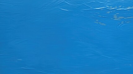 A textured blue surface with a subtle wave pattern.