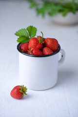 Cup filled with fresh strawberries. Seasonal summer berries, healthy dessert or snack.