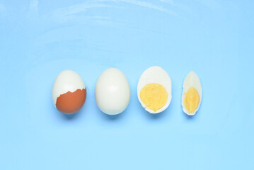 Tasty boiled eggs on blue background