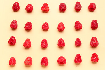 Many fresh raspberries on yellow background