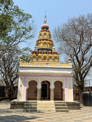 A small building with a pink and white color scheme