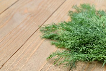 Fresh dill on wooden background