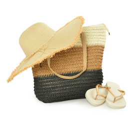 Stylish straw hat, beach bag and flip-flops on white background