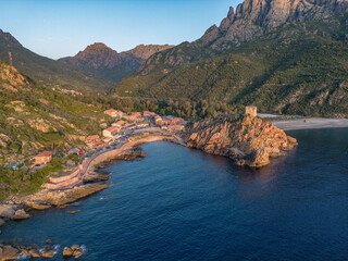 Aerial view town ruins Genoese tower of Porto Corsica France medieval watchtower Mediterranean Sea...