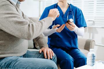 Nurse in blue scrubs reviews medication with an elderly patient at home, showcasing real people, compassionate care