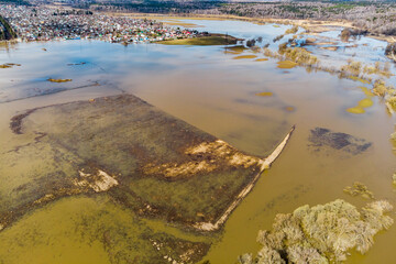 Bird's eye view of flooded floodplain fields in rural area during spring flood