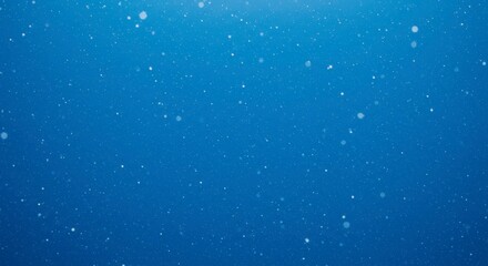 Fototapeta premium Abstract image with a deep blue background and tiny white particles floating throughout the space