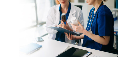 Medical team in hospital using digital tablet for diagnosis, teamwork, and patient care doctor and nurse collaboration