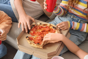 Group of young friends eating pizza at home party, closeup