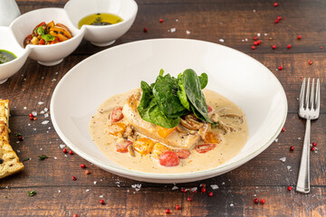 Tender chicken breast in creamy sauce with cherry tomatoes and spinach