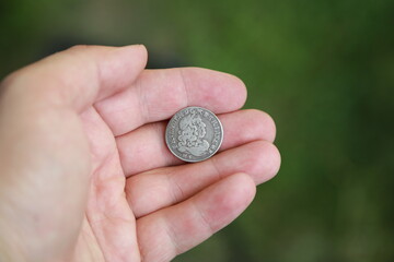 Medieval silver polish coin in hand