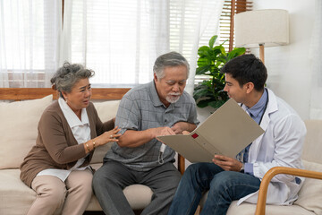 Doctor man explaining health examination results with Asian couple elderly patient at home visit. Retirement health care and life insurance concept