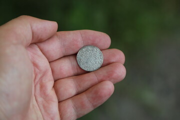 Medieval silver polish coin in hand