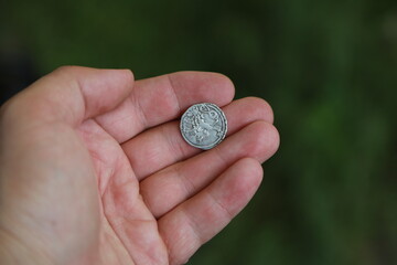 Medieval silver polish coin in hand