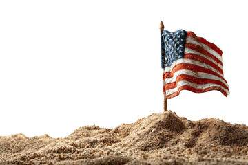 A small American flag stands atop a mound of sand, symbolizing patriotism and resilience.