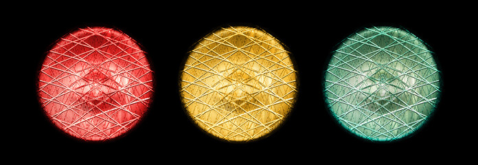 Green, yellow and red traffic lights with a black background.