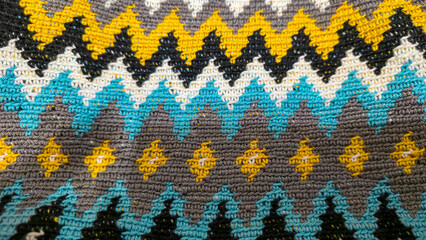 Crochet pattern of multicolored threads Yellow with gray, black and other colors